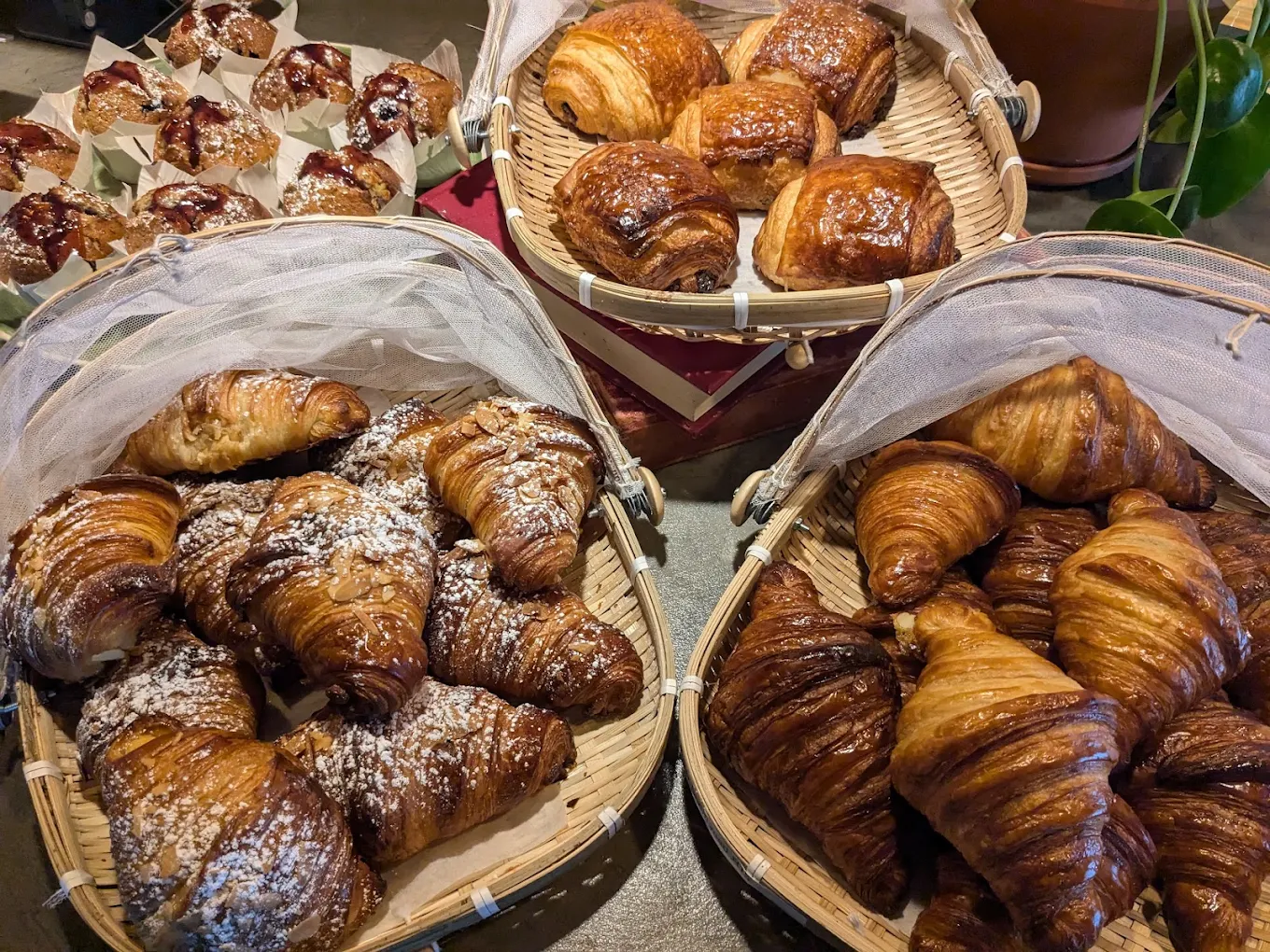 Fresh croissants displayed in baskets at Coffee Craft